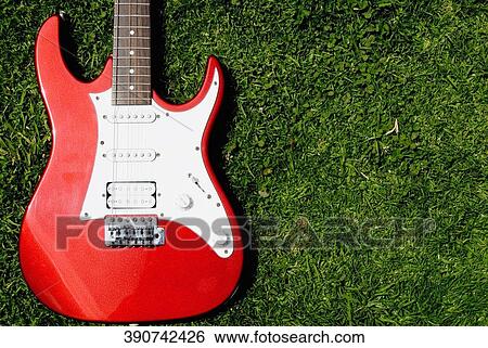 Close-up of an electric guitar on the grass View Large Photo Image Stock Photograph - Close-up of an electric guitar on the grass. Fotosearch