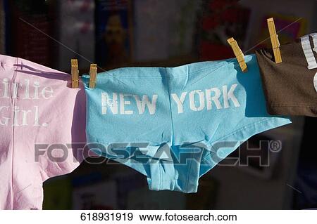 Stock Photo - Close-up of clothes hanging on a clothesline, New York City, New York State, USA. Fotosearch