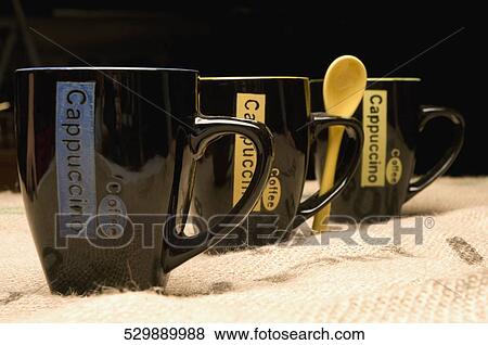 Close-up of coffee cups in a row View Large Photo Image Stock Photo - Close-up of coffee cups in a row. Fotosearch