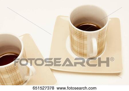 Stock Photo - Close-up of cups of black coffee in saucers. Fotosearch