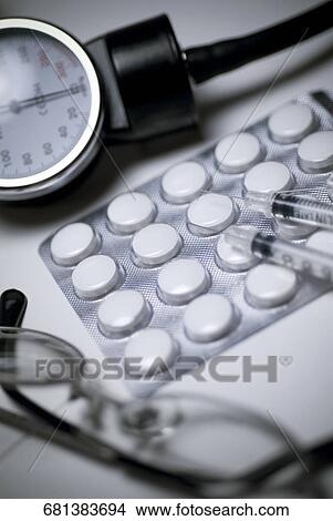 Close-up of eyeglasses and pills with medical equipments View Large Photo Image Picture - Close-up of eyeglasses and pills with medical equipments. Fotosearch