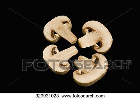 Stock Image - Close-up of four halves of mushrooms. Fotosearch