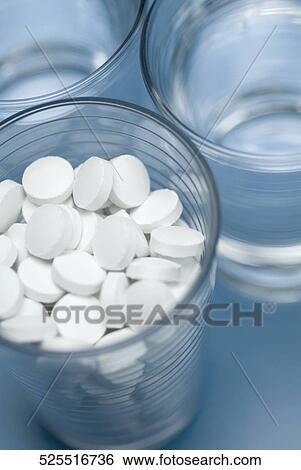 Close-up of glasses of water and pills View Large Photo Image Stock Photograph - Close-up of glasses of water and pills. Fotosearch