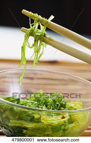 Close-up of salad in a bowl with chopsticks View Large Photo Image Stock Image - Close-up of salad in a bowl with chopsticks. Fotosearch