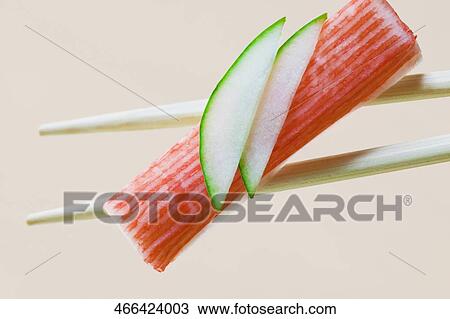 Close-up of sushi on chopsticks View Large Photo Image Stock Image - Close-up of sushi on chopsticks. Fotosearch
