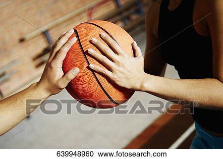 Close-up of two basketball players playing View Large Photo Image Stock Image - Close-up of two basketball players playing. Fotosearch