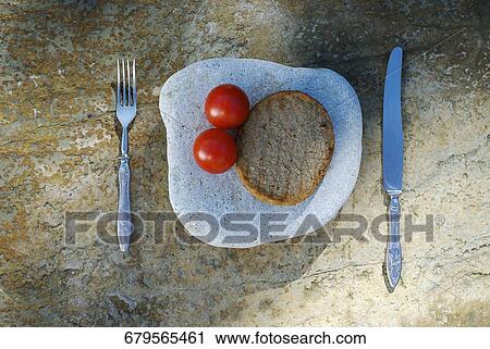 Close-up of two tomatoes with a bread on a stone View Large Photo Image Stock Image - Close-up of two tomatoes with a bread on a stone. Fotosearch