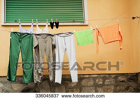 Clothes drying on a clothesline, Via Colombo, RioMaggiore, Cinque Terre, La Spezia, Genoa, Liguria, Italy View Large Photo Image Stock Photo - Clothes drying on a clothesline, Via Colombo, RioMaggiore, Cinque Terre, La Spezia, Genoa, Liguria, Italy. Fotosearch