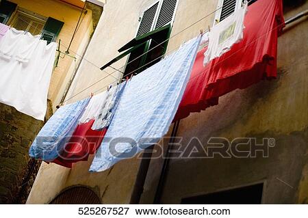 Clothes hanging to dry on a clothesline, Cinque Terre, La Spezia, Liguria, Italy View Large Photo Image Stock Photo - Clothes hanging to dry on a clothesline, Cinque Terre, La Spezia, Liguria, Italy. Fotosearch
