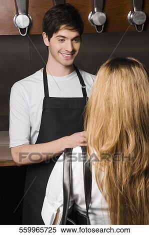 Coffee shop owner talking to a customer and smiling View Large Photo Image Stock Photography - Coffee shop owner talking to a customer and smiling. Fotosearch
