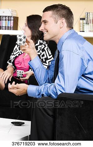 Couple having tea and smiling View Large Photo Image Stock Image - Couple having tea and smiling. Fotosearch