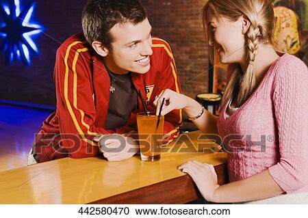 Stock Image - Couple looking at each other and smiling. Fotosearch