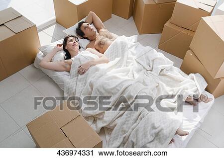 Couple lying on the bed View Large Photo Image Stock Image - Couple lying on the bed. Fotosearch