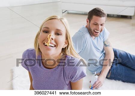 Couple sitting on rug and smiling View Large Photo Image Stock Image - Couple sitting on rug and smiling. Fotosearch