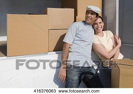 Couple standing together and smiling View Large Photo Image Stock Image - Couple standing together and smiling. Fotosearch