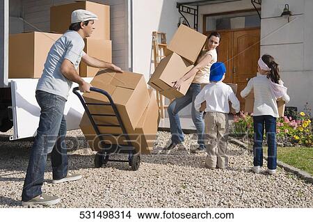 Couple with their children unloading goods from a pick-up truck View Large Photo Image Picture - Couple with their children unloading goods from a pick-up truck. Fotosearch