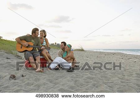 Couples enjoying on the beach View Large Photo Image Stock Photo - Couples enjoying on the beach. Fotosearch