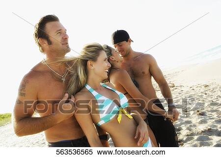 Couples enjoying on the beach View Large Photo Image Stock Photography - Couples enjoying on the beach. Fotosearch