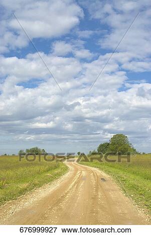 Stock Photo - Dirt road passing through a landscape. Fotosearch