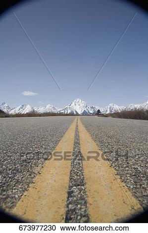 Dividing lines on a road with mountains in the background, Grand Teton National Park, Wyoming, USA View Large Photo Image Stock Image - Dividing lines on a road with mountains in the background, Grand Teton National Park, Wyoming, USA. Fotosearch