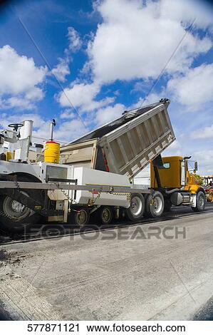 Dump truck and an asphalt paver at a road construction site, Biscayne Boulevard, Miami, Florida, USA View Large Photo Image Stock Image - Dump truck and an asphalt paver at a road construction site, Biscayne Boulevard, Miami, Florida, USA. Fotosearch