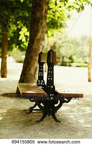 Empty bench in a park, Madrid, Spain View Large Photo Image Stock Photography - Empty bench in a park, Madrid, Spain. Fotosearch