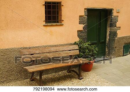 Empty bench with a potted plant outside a building, Vernazza, Cinque Terre National Park, Cinque Terre, La Spezia Province, Liguria, Italy View Large Photo Image Picture - Empty bench with a potted plant outside a building, Vernazza, Cinque Terre National Park, Cinque Terre, La Spezia Province, Liguria, Italy. Fotosearch