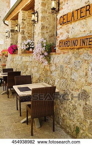 Empty chairs and tables at a sidewalk cafe, Piazza Roma, Monteriggioni, Siena Province, Tuscany, Italy View Large Photo Image Stock Image - Empty chairs and tables at a sidewalk cafe, Piazza Roma, Monteriggioni, Siena Province, Tuscany, Italy. Fotosearch