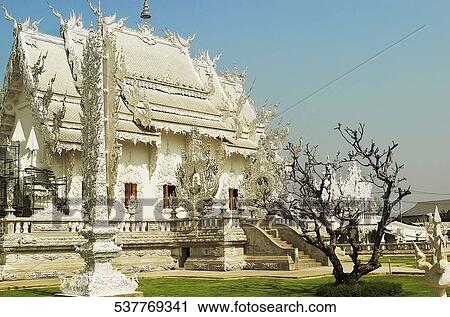 Stock Image - Facade of a temple, Wat Rong Khun, Chiang Rai, Amphoe Mueang, Chiang Rai Province, Thailand. Fotosearch