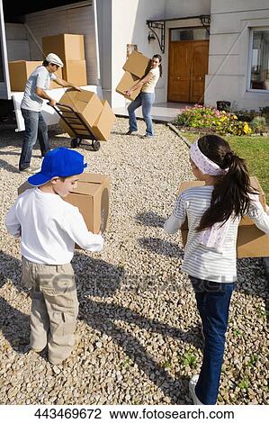 Family carrying cardboard boxes View Large Photo Image Stock Image - Family carrying cardboard boxes. Fotosearch