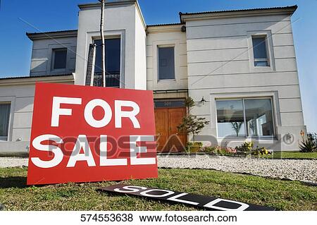 Stock Photo - For sale information board in front of a house. Fotosearch