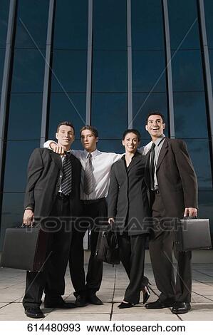 Four business executives smiling together View Large Photo Image Stock Image - Four business executives smiling together. Fotosearch