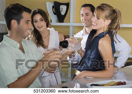 Four friends celebrating with cocktail View Large Photo Image Stock Image - Four friends celebrating with cocktail. Fotosearch