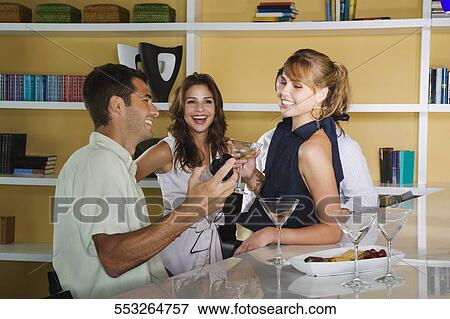 Four friends celebrating with cocktail View Large Photo Image Stock Photo - Four friends celebrating with cocktail. Fotosearch