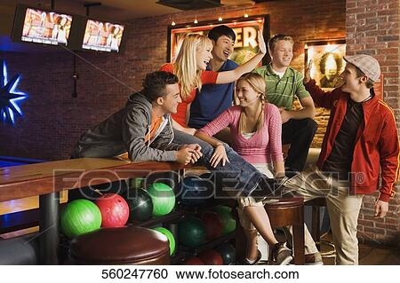 Friends enjoying at a bowling room View Large Photo Image Stock Image - Friends enjoying at a bowling room. Fotosearch