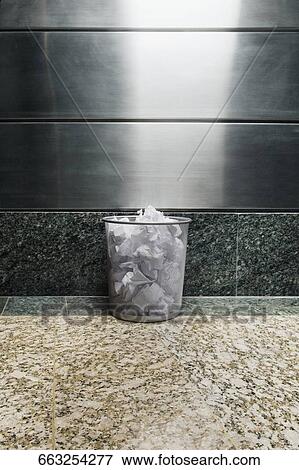 Garbage bin in front of a wall View Large Photo Image Stock Photo - Garbage bin in front of a wall. Fotosearch