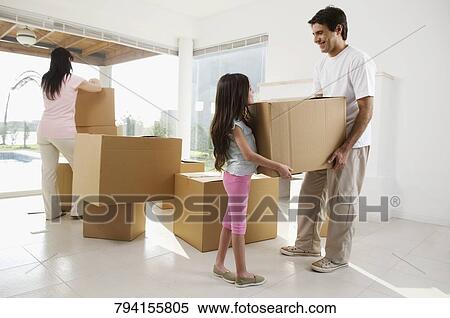 Girl carrying a cardboard box with her father View Large Photo Image Stock Photography - Girl carrying a cardboard box with her father. Fotosearch