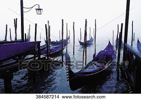 Gondolas moored with mooring posts in a canal, Grand Canal, Venice, Veneto, Italy View Large Photo Image Picture - Gondolas moored with mooring posts in a canal, Grand Canal, Venice, Veneto, Italy. Fotosearch