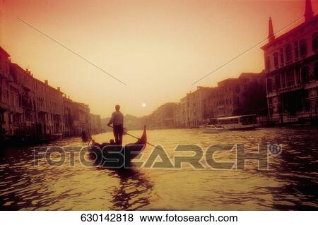 Gondolier rowing a gondola in a canal, Grand Canal, Venice, Veneto, Italy View Large Photo Image Stock Photo - Gondolier rowing a gondola in a canal, Grand Canal, Venice, Veneto, Italy. Fotosearch