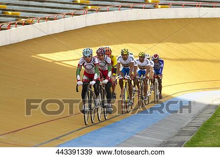 Stock Photo - Group of cyclists participating in velodrome. Fotosearch