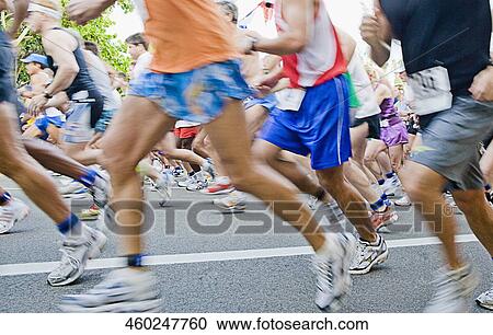 Stock Image - Group of people running a marathon. Fotosearch