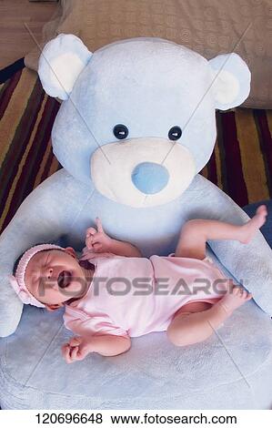 Stock Photo - High angle view of a baby girl crying. Fotosearch