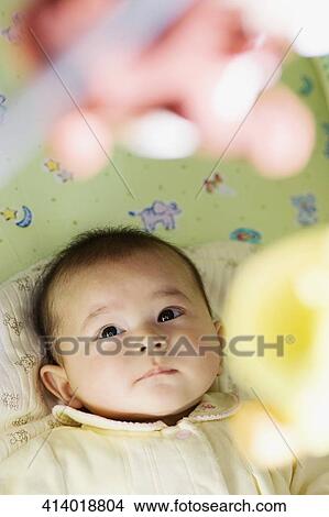High angle view of a baby girl looking at a mobile View Large Photo Image Picture - High angle view of a baby girl looking at a mobile. Fotosearch