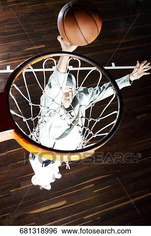 High angle view of a basketball player shooting a goal View Large Photo Image Stock Photograph - High angle view of a basketball player shooting a goal. Fotosearch
