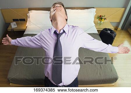 High angle view of a businessman standing with his arms outstretched in hotel room View Large Photo Image Stock Photography - High angle view of a businessman standing with his arms outstretched in hotel room. Fotosearch