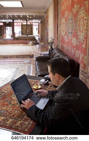 High angle view of a businessman using a laptop in a restaurant View Large Photo Image Picture - High angle view of a businessman using a laptop in a restaurant. Fotosearch