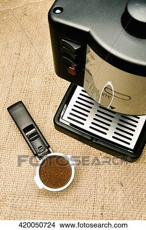 High angle view of a coffee maker and a sieve of coffee powder View Large Photo Image Picture - High angle view of a coffee maker and a sieve of coffee powder. Fotosearch