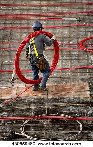 High angle view of a construction worker working at a construction site, New York City, New York State, USA View Large Photo Image Stock Image - High angle view of a construction worker working at a construction site, New York City, New York State, USA. Fotosearch