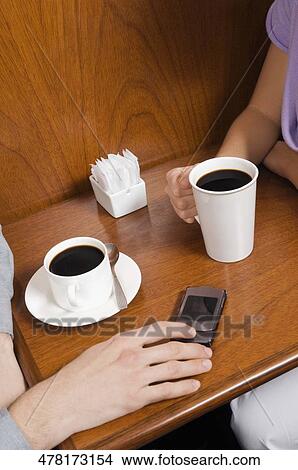 High angle view of a couple having black coffee in a cafe View Large Photo Image Picture - High angle view of a couple having black coffee in a cafe. Fotosearch