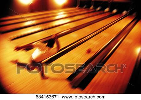 Stock Image - High angle view of a man bowling. Fotosearch